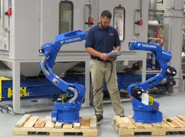 Two Yaskawa Motoman Model MH-12 robots are prepared for integration in robotic blasting systems