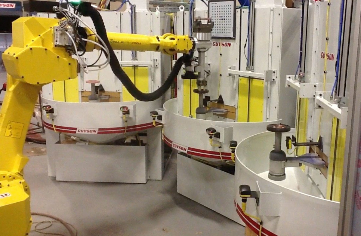 Robotic loading for a custom Multi blast cabinet used for electric motor parts.